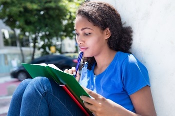 Female student annotating a book